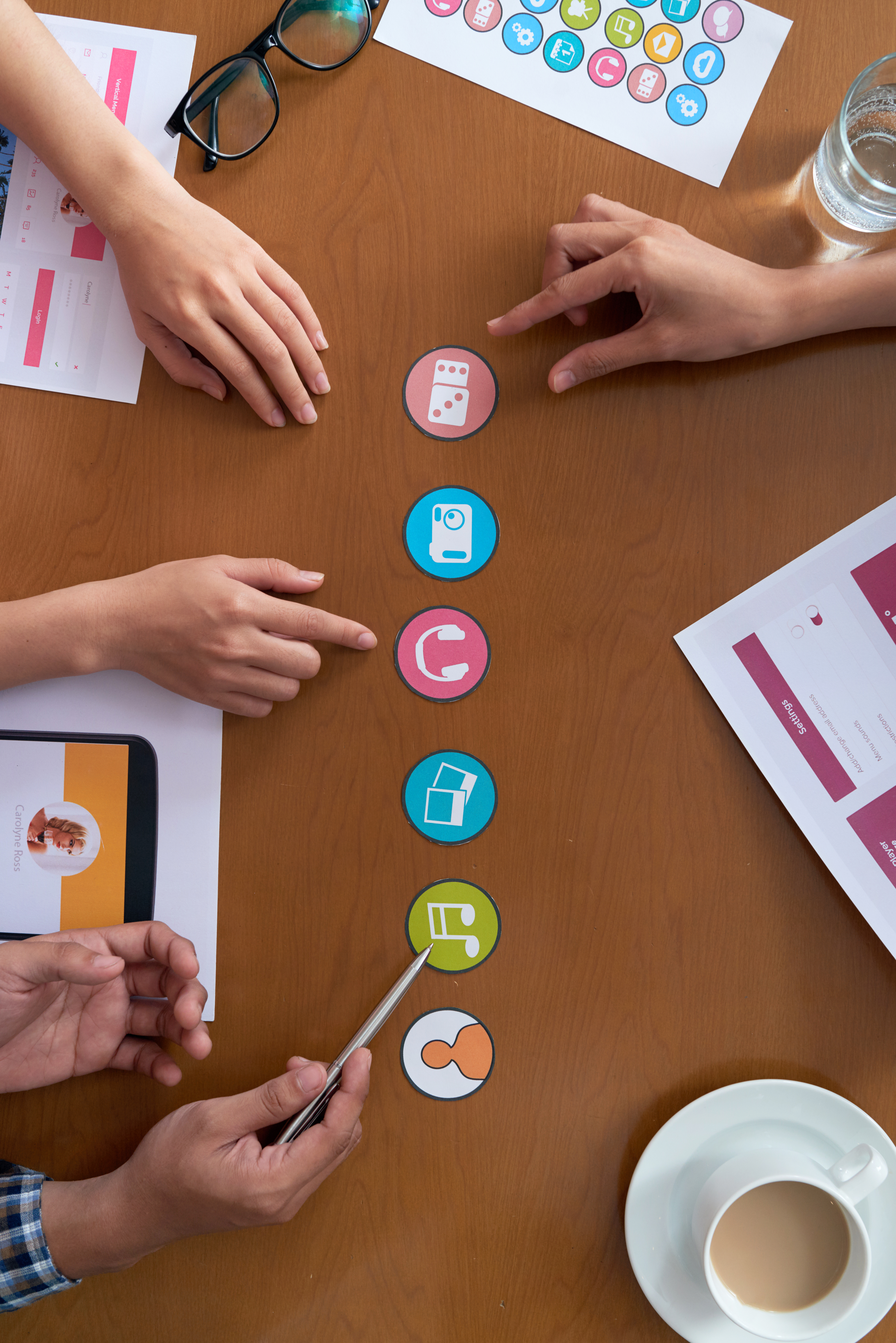 Hands of developers choosing icons to use in new mobile application